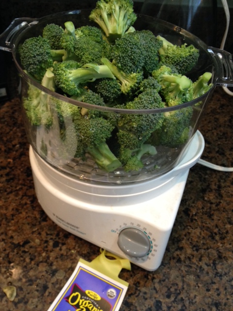 Put the trimmed broccoli in the steamer basket, cover and set the timer to the recommended cooking time.