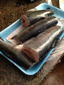 Start by cutting off the heads and tails. Use a very sharp knife.