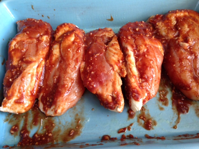 Basted chicken breasts ready to bake.